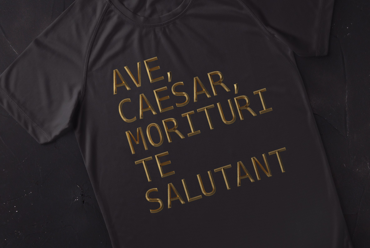 Dark t-shirt printed with a short Latin phrase in the Golden Rome Font