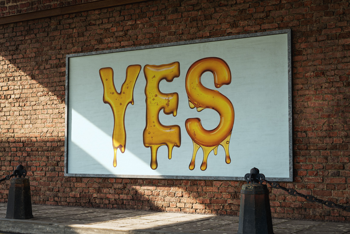 Lit billboard against brickwork reading YES in the Melted Honey Font