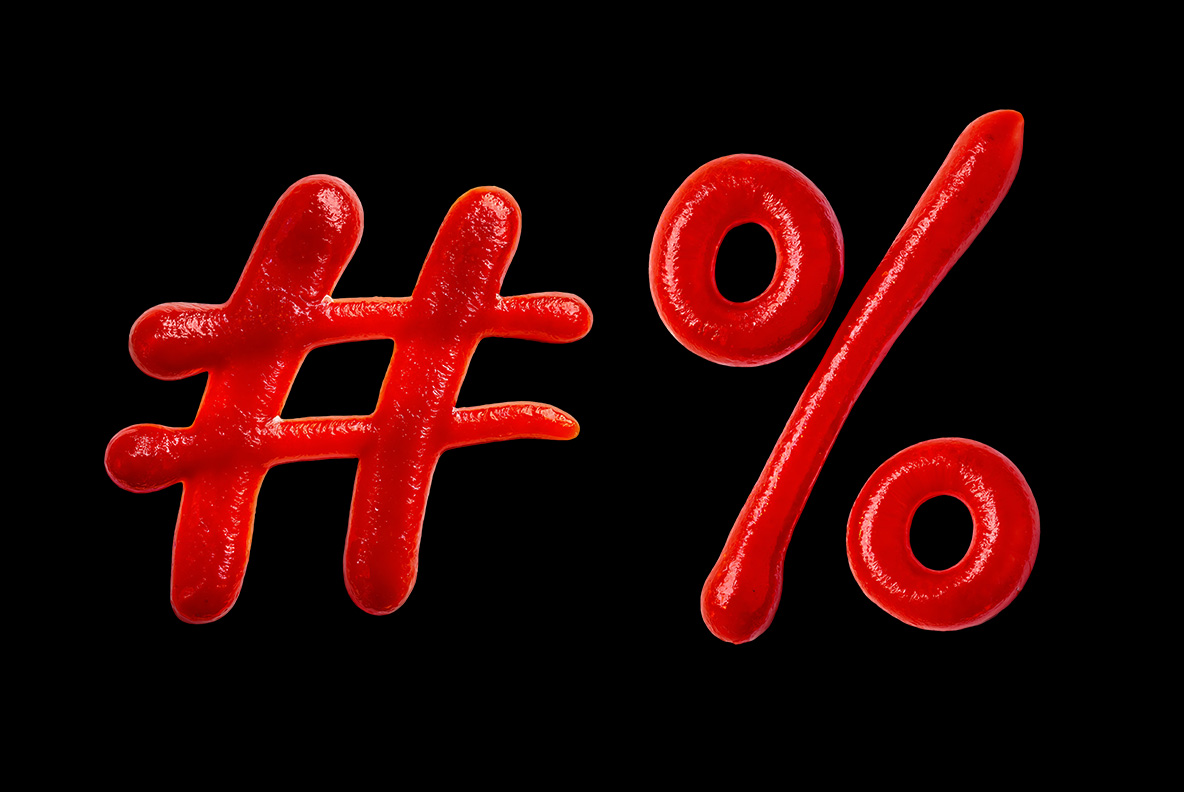 Hash And Percent Sign Of The Ketchup Script Font Hash and percent sign poured in glossy sauce on black from the Ketchup Script Font.