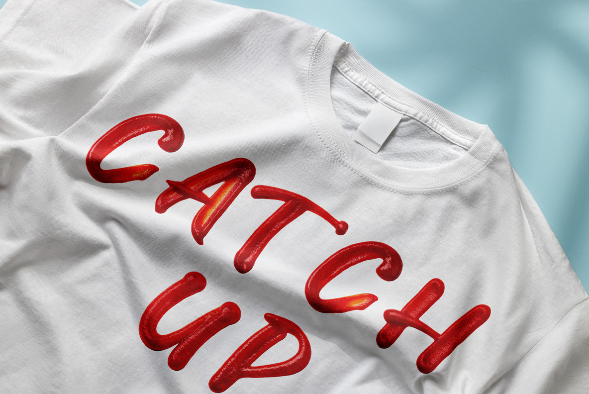 Ketchup Script Font Printed On A White T-Shirt White t-shirt mockup with a two-word phrase in the Ketchup Script Font.