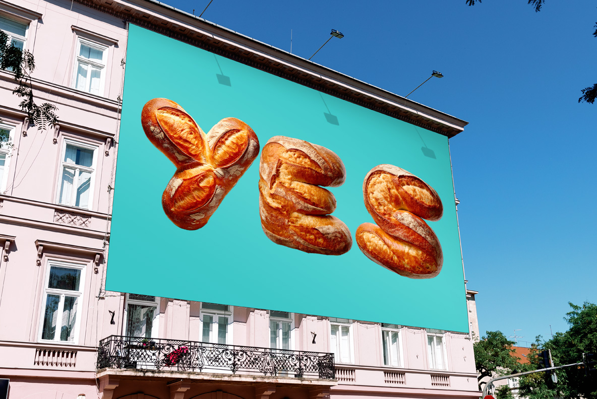 Large turquoise billboard on a pink building with a word in the Bakery Font.