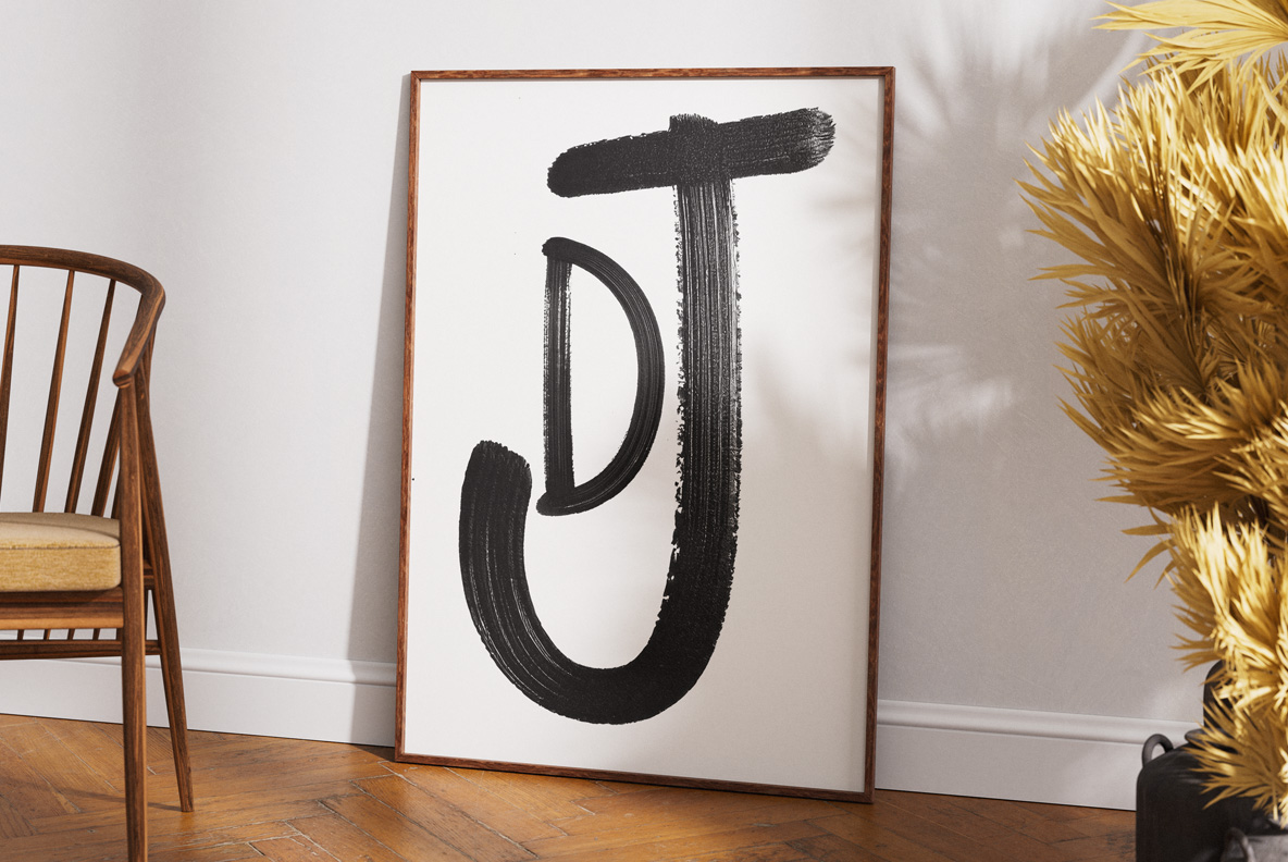 Framed interior print of a single painted letter J from the Paintbrush Flow Font.