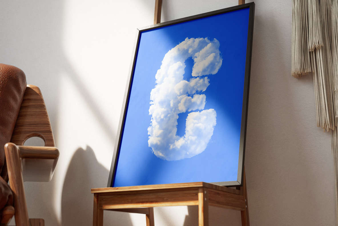 Puffy Clouds Font – Framed Number 6 Interior Mockup Puffy Clouds Font number 6 formed from soft white clouds on blue, displayed in a framed interior poster.