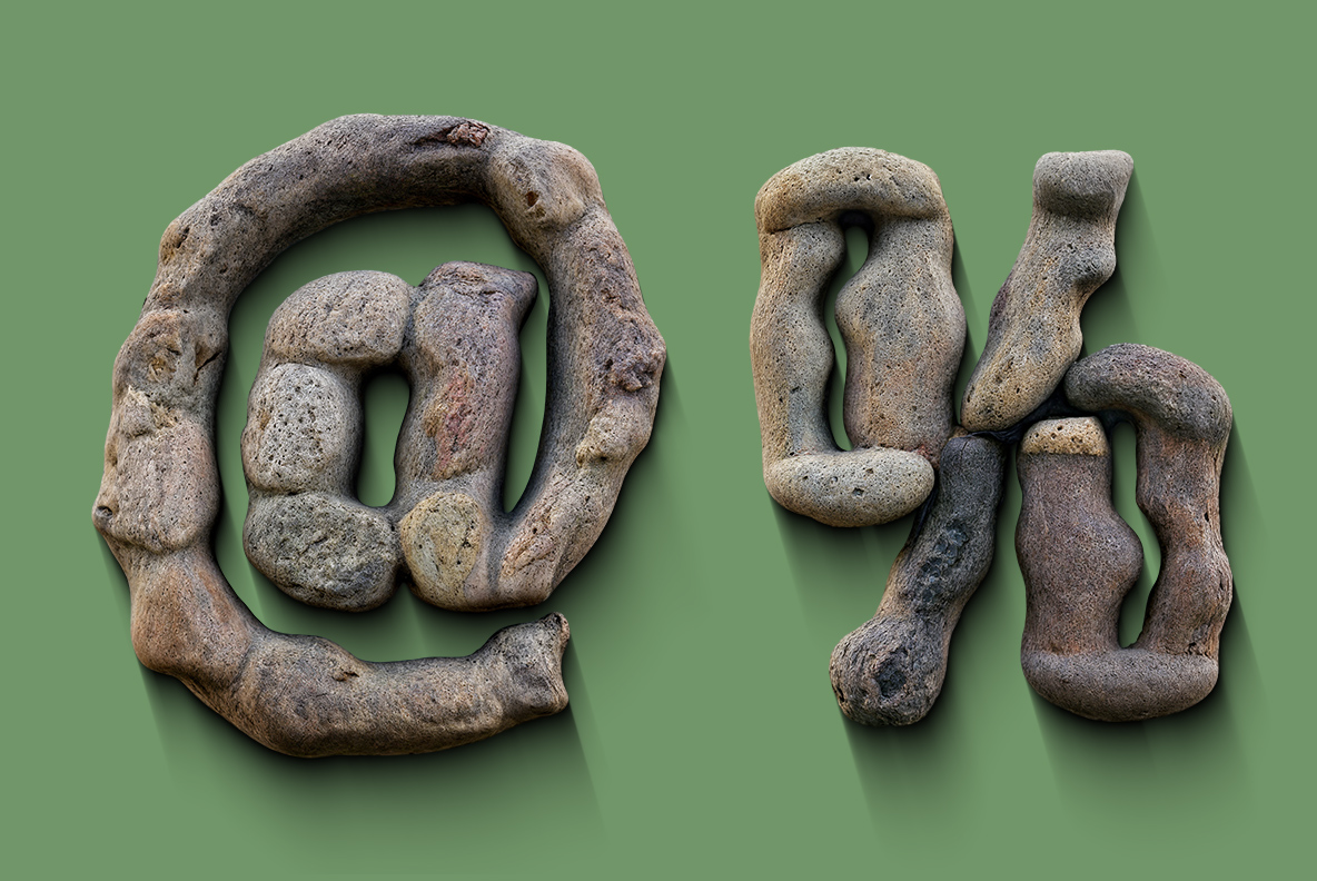 Stone Stack Font At Sign and Percent Symbol At sign and percent symbol from the Stone Stack Font on a sage green background